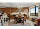 Dining room features wood table and chairs, decorative hutch, granite countertops and a view from a large window at 111 E Monument Ave # 705, Kissimmee, FL 34741