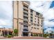 Attractive condo building exterior shows balconies, architectural details, and awnings at 111 E Monument Ave # 705, Kissimmee, FL 34741