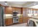 Modern kitchen featuring stainless steel appliances, granite countertops, and wooden cabinetry at 111 E Monument Ave # 705, Kissimmee, FL 34741