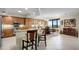 Open kitchen featuring granite counters, stainless appliances, island seating, and adjoining dining area at 111 E Monument Ave # 705, Kissimmee, FL 34741