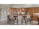 Kitchen with granite countertops, stainless steel appliances, a breakfast bar, and wooden cabinets at 111 E Monument Ave # 705, Kissimmee, FL 34741