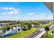 Scenic lake view from a high-rise condo showcasing lush greenery, a pond, and clear blue skies at 111 E Monument Ave # 705, Kissimmee, FL 34741