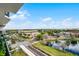 Scenic lake view from a high-rise condo showcasing lush greenery, a pond, and clear blue skies at 111 E Monument Ave # 705, Kissimmee, FL 34741