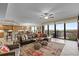 Open-concept living room featuring tile floors, a leather sectional, and a large patio door at 111 E Monument Ave # 705, Kissimmee, FL 34741