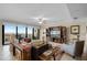 Spacious living room featuring a large leather sofa, stylish decor, and balcony with water views at 111 E Monument Ave # 705, Kissimmee, FL 34741