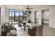 Comfortable lobby seating area with ceiling fan, potted plants, and large window featuring a city view at 111 E Monument Ave # 705, Kissimmee, FL 34741