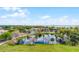 Aerial view of a serene pond with a fountain, surrounded by lush greenery and trees at 111 E Monument Ave # 705, Kissimmee, FL 34741