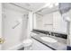 This bathroom features a stand up shower and granite counters at 1100 Delaney Ave # F409, Orlando, FL 32806