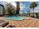 Community pool with plenty of seating and a great lake view at 1100 Delaney Ave # F409, Orlando, FL 32806