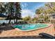 Community pool with plenty of seating and a lake view at 1100 Delaney Ave # F409, Orlando, FL 32806