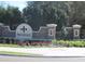 Community entrance sign with brick pillars and flowerbeds at 13413 Zori Ln, Windermere, FL 34786