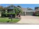 Charming home featuring a well-manicured lawn, brick driveway, and a two-car garage at 13413 Zori Ln, Windermere, FL 34786