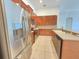 Kitchen boasts wood cabinets, stainless steel fridge, a sink, and countertops at 13413 Zori Ln, Windermere, FL 34786