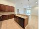 View of a kitchen area with wood cabinets, a counter-height eating bar, and a sink at 13413 Zori Ln, Windermere, FL 34786