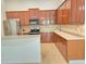 Bright kitchen with rich wood cabinetry, stainless steel appliances, and a large island at 13413 Zori Ln, Windermere, FL 34786