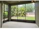 Screened lanai showcasing outdoor living space with views of the lush backyard at 13413 Zori Ln, Windermere, FL 34786