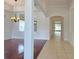 Bright living room featuring hardwood floors, a decorative chandelier, and archway to an adjacent tiled room at 13413 Zori Ln, Windermere, FL 34786