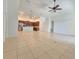 Open-concept living room with tile flooring flowing into a kitchen with stainless steel appliances and brown cabinets at 13413 Zori Ln, Windermere, FL 34786