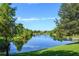 A picturesque pond surrounded by lush landscaping offers a serene escape within the community at 13413 Zori Ln, Windermere, FL 34786