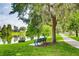 A serene pond view with mature trees and a relaxing bench offers a peaceful escape at 13413 Zori Ln, Windermere, FL 34786