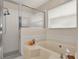 Bathroom featuring shower, bathtub and a window at 14540 Pointe East Trl, Clermont, FL 34711