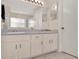 Neutral-toned bathroom with a double vanity, large mirror, and plenty of storage space at 14540 Pointe East Trl, Clermont, FL 34711
