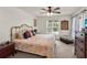 Comfortable bedroom with soft lighting, a cozy bed, and a view of the outside at 14540 Pointe East Trl, Clermont, FL 34711