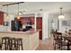 Stylish kitchen with a breakfast bar, stainless steel appliances, and warm lighting at 14540 Pointe East Trl, Clermont, FL 34711
