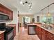 Well-equipped kitchen with stainless steel appliances, abundant storage, and tiled flooring at 14540 Pointe East Trl, Clermont, FL 34711