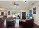 Spacious living room with outdoor views, a ceiling fan, and dark hardwood floors at 14540 Pointe East Trl, Clermont, FL 34711