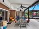 Cozy covered patio with comfortable seating, ceiling fans, and views of the backyard at 14540 Pointe East Trl, Clermont, FL 34711