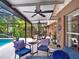 Charming outdoor patio with ample seating, ceiling fans, and a view of the lush, private backyard at 14540 Pointe East Trl, Clermont, FL 34711