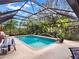 Beautiful screened-in pool with inviting blue water, a fountain feature, and comfortable lounge chairs at 14540 Pointe East Trl, Clermont, FL 34711