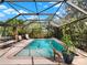 Inviting screened-in pool with clear blue water, a fun giraffe statue, and plenty of space for lounging at 14540 Pointe East Trl, Clermont, FL 34711