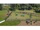 Aerial view of a fenced dog park with play equipment and benches, perfect for pet owners in the community at 146 Jones Fish Camp Rd, Edgewater, FL 32141