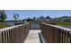 Scenic view of a pond and nearby townhomes as seen from a wooden walkway within the community at 146 Jones Fish Camp Rd, Edgewater, FL 32141