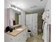 Bathroom features sink and vanity, medicine cabinet, and a tiled shower with curtain at 1489 Magellan Cir # 603, Orlando, FL 32818
