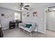 This bedroom features a ceiling fan, a comfy couch, and natural light coming through the window at 1489 Magellan Cir # 603, Orlando, FL 32818