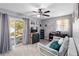 A cozy bedroom featuring a comfortable couch, a ceiling fan, and sliding glass doors to the outside at 1489 Magellan Cir # 603, Orlando, FL 32818