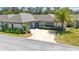 Charming villa with a two-car garage, mature landscaping, and a driveway that's perfect for guest parking at 1489 Magellan Cir # 603, Orlando, FL 32818