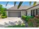 Inviting single-story home featuring a two-car garage, manicured landscaping, and a cozy front entrance at 1489 Magellan Cir # 603, Orlando, FL 32818