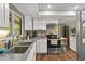 Bright kitchen features stainless steel appliances, white cabinets, and wood flooring at 1489 Magellan Cir # 603, Orlando, FL 32818