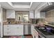 Bright kitchen features stainless steel appliances, white cabinets, and wood flooring at 1489 Magellan Cir # 603, Orlando, FL 32818