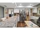 Bright kitchen featuring stainless steel appliances, white cabinets, and a view into the adjacent living area at 1489 Magellan Cir # 603, Orlando, FL 32818