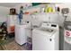 A spacious laundry room with a utility sink and appliances at 1489 Magellan Cir # 603, Orlando, FL 32818