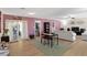 Bright and open living room featuring wood floors, a dining table, a ceiling fan, and access to the patio at 1489 Magellan Cir # 603, Orlando, FL 32818
