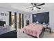 Main bedroom features gray carpet, neutral paint, ceiling fan, and sliding glass doors at 1489 Magellan Cir # 603, Orlando, FL 32818