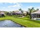 Lush backyard with a screened enclosure and a serene pond view, perfect for outdoor relaxation and enjoyment at 1640 Prairie Oaks Dr, St Cloud, FL 34771