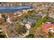 Aerial view of property showing lake, home, and landscaping, including a glimpse of the screened in lanai at 1704 Kersley Cir, Lake Mary, FL 32746