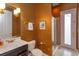 Elegant bathroom featuring a glass shower, decorative wallpaper, a framed picture and vanity sink at 1704 Kersley Cir, Lake Mary, FL 32746